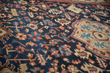 Persian Gorevan rug's navy field, blush palmettes, and beige Turtle Samovar border motif.