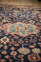 Close-up of vintage Gorevan carpet, navy field with blush palmettes and geometric Turtle Samovar border.