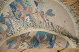 The plain weave foundation and secured fringe on the back of a vintage Art Deco round rug.
