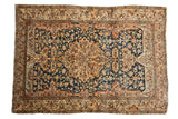 Fine antique Persian Malayer rug with a roundel center medallion over a dusty navy blue vining field.
