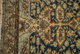 Detail of the floral main border and tattered edge on an antique tea-washed Malayer rug.