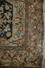 Detail of the floral cross-section border and tattered side on an antique Persian Malayer rug.