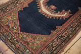 Corner detail of an antique Persian saddle cover highlighting the intricate spandrel and geometric borders.