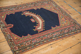 An antique Northwest Persian saddle cover's unique horn-shaped motif and colorful geometric spandrels.