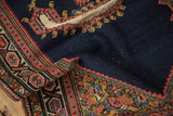 Detail of a weighted corner spandrel with Herati motifs and storied wear on an antique Persian saddle cover.