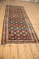 Antique Malayer runner end, featuring geometric patterns, meandering borders, and lightly tattered fringe.