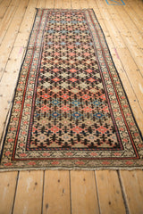 Antique Kurdish Malayer runner corner featuring lightly tattered fringe and red, black, and beige meandering borders.