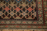 Antique Kurdish Malayer rug corner, showing geometric floral pattern, beige and ruby red borders, and light tatter fringe.