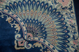 Antique Art Deco rug corner: peacock motif in cobalt, sky blue, and dusty rose.