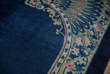 Antique Art Deco carpet's cobalt blue field and corner with dusty rose peacock and arabesques.