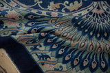 Art Deco carpet's deep cobalt border and patterned field with peacock eyes and dusty rose tendrils.