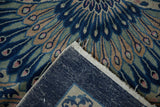 Detail of hand-knotted Art Deco rug, showing intricate cobalt blue peacock design and rug foundation.