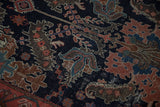 Antique Malayer rug fragment with madder red palmettes, stylized leaves, and navy field texture.