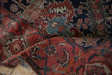 Close-up of antique Malayer runner, showing worn ruby red, navy, sky blue stylized palmettes and leaves.