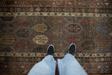 A viewer's perspective of the polychromatic botehs and lustrous wool on an antique Hamadan runner.