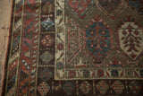 Paneled borders and lustrous hand-knotted pile of an antique Kurdish Hamadan rug corner.
