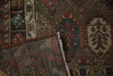 Corner detail of an antique Hamadan rug showing its hand-knotted foundation and fine wool pile.