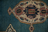 Stylized shield overlay with beige and navy details on a vintage Bakshaish rug's blue field.