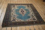 Vintage Bakshaish collector rug displaying a shield-like medallion on an aquatic blue field and dark geometric border.