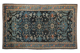 Fine distressed Lilihan rug with shadow medallions on a charcoal navy field with dusty teal and copper accents.