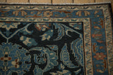 Scrolled leaves and delicate vines in the dusty teal, beige, and copper borders of a vintage Lilihan rug.