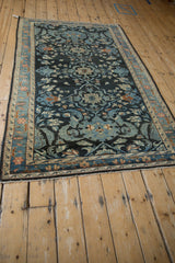 Angled view showing the flow of shadow medallions on a distressed vintage Lilihan Persian rug.