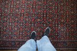 Balanced Herati design of a vintage Sarouk rug with cherry red and navy blue palmettes.