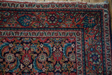 Meandering vine and blossom palmette main border on a vintage Persian Sarouk rug corner.
