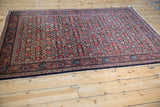 Angled view of the vintage Sarouk rug's dense allover Herati design.