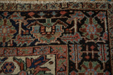 Close-up of Gorevan rug's rare checkered border and gem-tone geometric floral motifs.