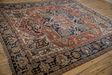 Traditional Gorevan carpet displaying geometric buds, rare checkered border, brick red, and navy.