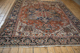 Detail of vintage Gorevan carpet: unique checkered floral border in navy, brick red, and beige.