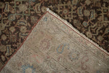 Antique Persian Malayer rug corner folded over, showing the hand-knotted foundation and pile.