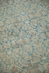 Distressed vintage Meshed carpet detail, displaying worn Herati pattern in dusty blue and cream.