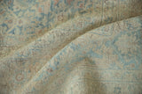 Close-up of vintage distressed Meshed carpet pile, tone-on-tone blue, cream, and brown Herati motifs.