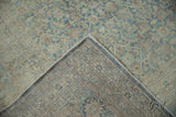 Distressed vintage Meshed rug corner, showing pile texture, hand-knotted foundation, and selvage.