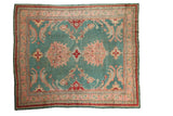 Vintage Oushak carpet with muted jade green field, quatrefoil medallion, and large scale palmette motifs.