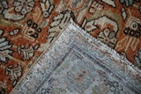 Mahal carpet's hand-knotted foundation showing knot heads, selvage, and rust pile.