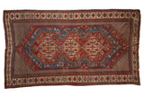 Antique Qashqai carpet with three interconnected geometric medallions in burgundy red and sapphire blue.