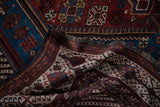 Detailed view of the intricate weave and secured fringe on an antique Persian Qashqai carpet.