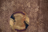 Close view of an antique Peking rug's medallion showing areas of pile and knot heads.