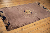 Antique Peking rug laid flat, showing the light rippling along the original side cord selvages.