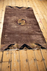 Full length view of the antique Peking runner showing the dusty lavender field and slight rippling along its edges.