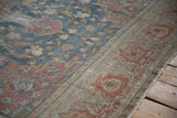 Distressed Farahan Sarouk rug. Worn floral motifs with time-softened dusty blue, blush, and sand.