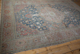Worn Farahan Sarouk carpet detail with dusty blue field, blush border, and exposed foundation.