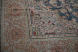 Distressed Farahan Sarouk rug, intricate floral arabesque in dusty rose, blue, and sand tones.