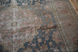 Distressed vintage Farahan Sarouk rug with abrashed blue, rose, and sand curvilinear floral motifs.