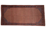 Antique Qashqai rug runner, madder red field with repeating vinery, navy blue lattice spandrels.