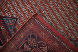 Antique Qashqai rug corner showing blue spandrel, red selvage, and hand-knotted plain weave.