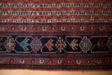 Antique Qashqai runner border featuring stylized tribal birds and geometric designs.